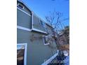 Green-sided house exterior showcasing side windows and landscaping at 10703 Jordan Ct, Parker, CO 80134