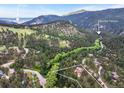 Aerial view of the property nestled amongst trees within Boulder Canyon, with proximity to Boulder city at 207 Kelly E Rd, Boulder, CO 80302