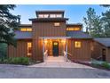 Charming home featuring covered entryway with decorative columns, dark green front door, and manicured landscaping at 207 Kelly E Rd, Boulder, CO 80302