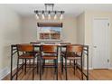 Charming dining area with modern light fixture and hardwood floors, perfect for Gathering gatherings at 2415 E Maplewood Ave, Centennial, CO 80121