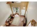 Bright entryway features hardwood floors, a ceiling fan, and a view of the front door and bay window at 4784 Raven Run, Broomfield, CO 80023