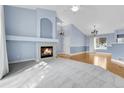 Bright living room with fireplace, vaulted ceilings, and hardwood floors at 9585 Brentwood Way # D, Westminster, CO 80021