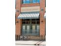 Close up view of the front of the building showing a light awning over the windows at 2245 Blake St # C, Denver, CO 80205