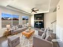 Bright living room features a modern fireplace, large windows, and stylish gray furniture at 5470 Danube St, Denver, CO 80249