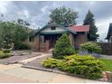 Beautiful brick home with a red roof and lush landscaping at 1881 S Lincoln St, Denver, CO 80210