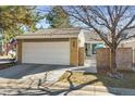 Charming single Gathering home featuring a two-car garage and flag at 7255 S Vine St, Centennial, CO 80122