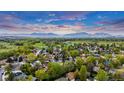 Aerial view of a neighborhood with snow-capped mountains in the background on a beautiful day at 323 S Hoover Ave, Louisville, CO 80027