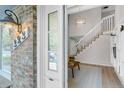 Inviting entryway with view of the staircase, living room, and built in shelving. Lots of natural light at 323 S Hoover Ave, Louisville, CO 80027