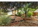 Landscaped front yard with rock features, brick accents and a large tree providing plenty of shade at 323 S Hoover Ave, Louisville, CO 80027