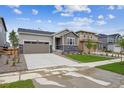 Lovely single-Gathering home featuring stone accents, a two-car garage, and a well-manicured lawn at 24747 E 40Th Ave, Aurora, CO 80019