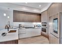 Modern kitchen featuring sleek cabinets, stainless steel appliances, and stylish lighting at 4200 W 17Th Ave # 619, Denver, CO 80204