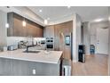 Elegant kitchen with stainless appliances, quartz counters, and designer backsplash at 4200 W 17Th Ave # 619, Denver, CO 80204