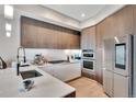 Modern kitchen featuring sleek cabinets, stainless steel appliances, and stylish lighting at 4200 W 17Th Ave # 619, Denver, CO 80204