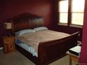 Primary bedroom with a large sleigh bed and natural light from two windows at 12317 W Gould Ave, Littleton, CO 80127