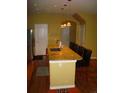 Kitchen island with granite countertop, sink, pendant lights and four bar stools at 12317 W Gould Ave, Littleton, CO 80127