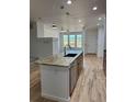 Modern kitchen features a central island with granite countertops and stainless steel appliances at 12317 W Gould Ave, Littleton, CO 80127