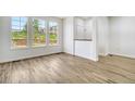 Living room with hardwood floors, three windows, and white walls for a bright and modern feel at 12317 W Gould Ave, Littleton, CO 80127