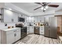 Modern kitchen with gray cabinets, stainless steel appliances, and countertops, creating a functional and stylish space at 6761 Harlan St, Arvada, CO 80003