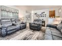 Cozy living room showcasing comfortable seating and a decorative wall art, creating a welcoming atmosphere at 6761 Harlan St, Arvada, CO 80003