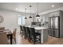 Modern kitchen with stainless steel appliances, kitchen island and bar stool seating at 9157 Rio Lado St, Littleton, CO 80125