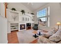 Bright living room featuring a fireplace, soaring ceilings, and large windows at 11803 W Stanford Dr, Morrison, CO 80465