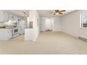 Neutral living room featuring white walls, carpeted floors and a connecting opening to the kitchen at 8100 W Quincy Ave # A8, Littleton, CO 80123