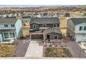 Two-story home boasts attached garage, complemented by xeriscaping and drought-resistant plants in a Gathering-friendly neighborhood at 4807 River Highlands Loop, Elizabeth, CO 80107
