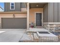 The front entrance has neutral colors and a two-car garage, offering an inviting facade and convenience at 4807 River Highlands Loop, Elizabeth, CO 80107