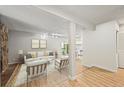 Bright living room with wood floors, a white couch, and open access to the kitchen at 2678 S Xanadu Way # C, Aurora, CO 80014