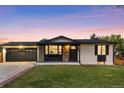 Inviting home exterior with stone accents, an attached two car garage, and pristine lawn at 6369 W 69Th Ave, Arvada, CO 80003