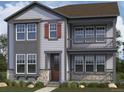 Charming two-story home featuring stone accents, shutters, a cozy porch, and a classic design for comfortable living at 24207 E 53Rd Dr, Aurora, CO 80019