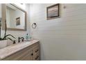 Charming bathroom featuring shiplap walls, granite countertop and modern fixtures at 18096 E 104Th Way, Commerce City, CO 80022