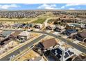 Expansive aerial view showing the property within a vibrant neighborhood, golf course, and open spaces at 7743 S Quantock Way, Aurora, CO 80016