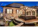 Inviting backyard featuring a cozy lounge area with fire pit and string lights at 7743 S Quantock Way, Aurora, CO 80016