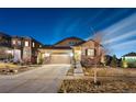 Charming two-story home with a well-manicured lawn, attached garage, and stone accents at 7743 S Quantock Way, Aurora, CO 80016