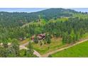 Beautiful mountain home situated on a large lot surrounded by lush trees at 9745 Hilldale Dr, Morrison, CO 80465
