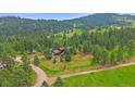 Beautiful mountain home situated on a large lot surrounded by lush trees at 9745 Hilldale Dr, Morrison, CO 80465