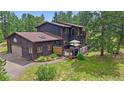 Charming two-story home featuring an attached garage and spacious outdoor deck at 9745 Hilldale Dr, Morrison, CO 80465