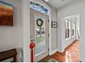 Bright entryway with stained glass transom, hardwood floors, and view to living room at 1717 E 22Nd Ave, Denver, CO 80205