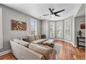 Cozy living room featuring hardwood floors, large sectional sofa, and abundant natural light at 1717 E 22Nd Ave, Denver, CO 80205
