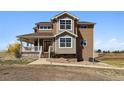 Lovely home with a welcoming front porch, complemented by well-maintained landscaping at 1212 N County Road 125, Bennett, CO 80102