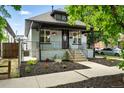 Charming home showcasing a covered front porch and beautiful flowerbeds at 4059 Quivas St, Denver, CO 80211