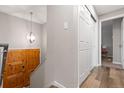 Bright entryway featuring a wooden door, white walls, and a stylish light fixture at 8506 Eaton St, Arvada, CO 80003