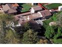 A sprawling property with a main house, carriage house, mature trees, and a private backyard space at 4500 Zephyr St, Wheat Ridge, CO 80033