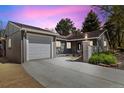 Charming single-story home with attached garage, complemented by manicured landscaping and a picturesque setting at 4500 Zephyr St, Wheat Ridge, CO 80033