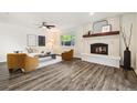 Cozy living room with a decorative fireplace, wood floors, and modern furnishings at 4500 Zephyr St, Wheat Ridge, CO 80033