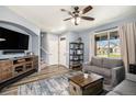 Cozy living room with wood floors, a ceiling fan, and a comfortable gray couch at 2516 Mountain Sky Dr, Castle Rock, CO 80104