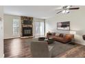 Inviting living room featuring a stone fireplace, ceiling fan, and access to the backyard at 1639 S Ivory Cir # C, Aurora, CO 80017