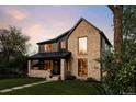 Charming two-story home showcasing brick, dark siding, and lush green lawn with sidewalk pathway at 1680 S Humboldt St, Denver, CO 80210