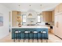 Bright, modern kitchen with a large island, stylish stools, and stainless steel appliances at 1680 S Humboldt St, Denver, CO 80210